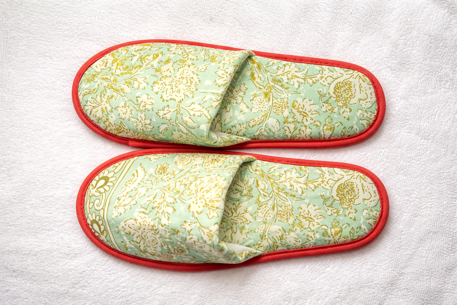 Blue floral custom hotel slippers for guest rooms manufactured by Hygienix Hospitality India